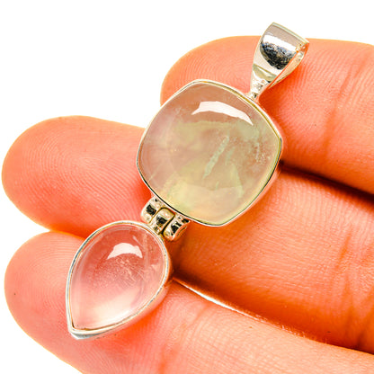 Two-stone pendant close-up with translucent green and rose pink cabochons, silver setting