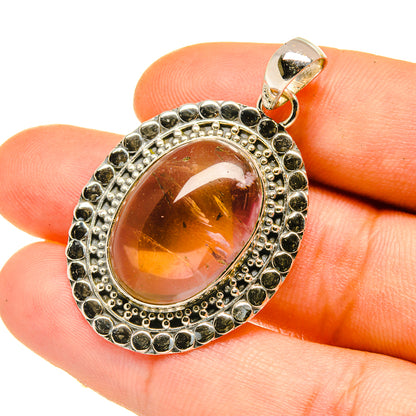 Oval sterling silver ametrine pendant with dark bead halo and amber-pink cabochon