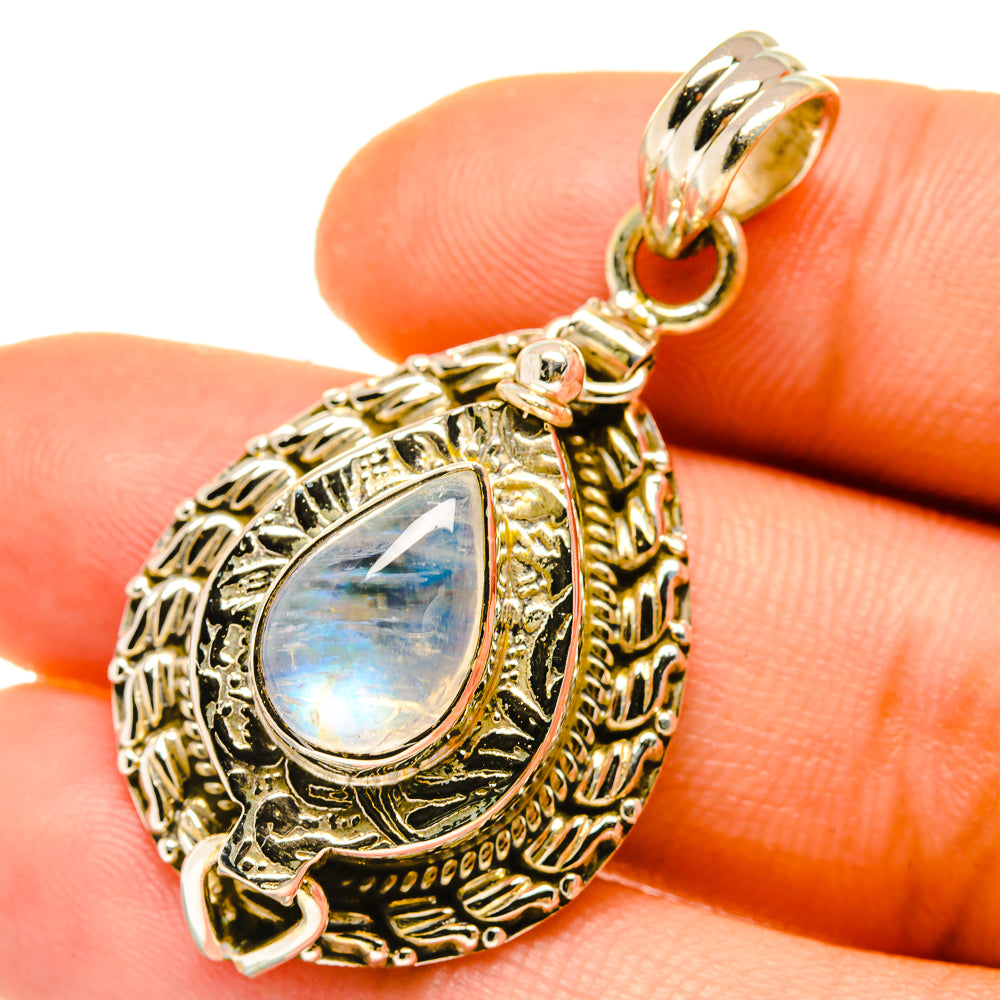 Teardrop moonstone pendant close-up on gold-tone filigree with loop bail