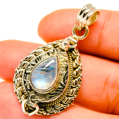 Teardrop moonstone pendant close-up on gold-tone filigree with loop bail