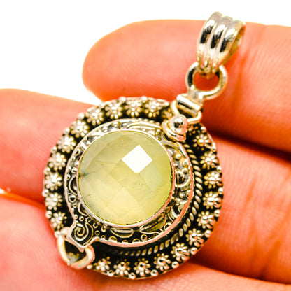 Sterling silver prehnite poison pendant with round yellow-green stone, ornate bezel