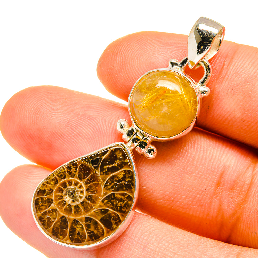 Sterling silver ammonite fossil pendant with yellow rutilated quartz on finger