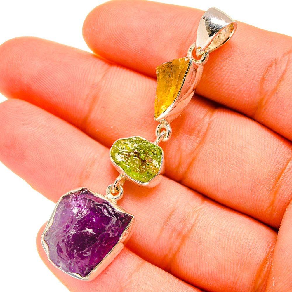 Rough amethyst, peridot, and citrine stones pendant hanging from gold-tone bail