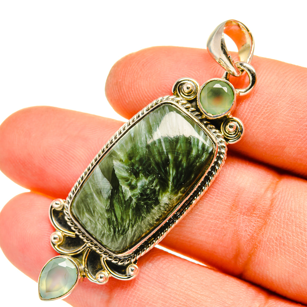 Sterling silver pendant with green rectangular stone, small green cabochons, orange accent