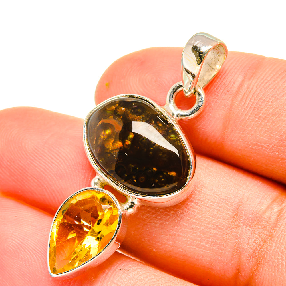 Fire agate and citrine pendant close-up with oval dark stone and yellow teardrop in silver