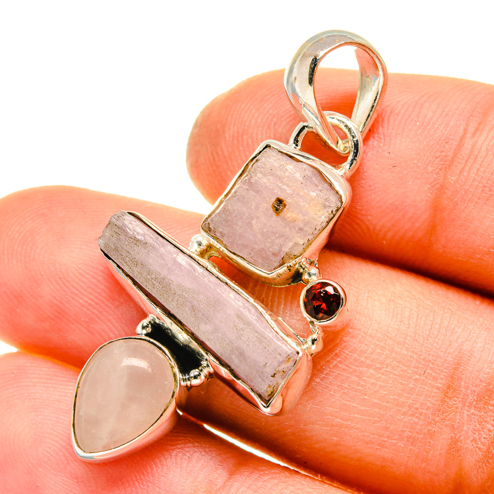 Sterling silver pendant with rough pink kunzite, pale round stone, and small red garnet