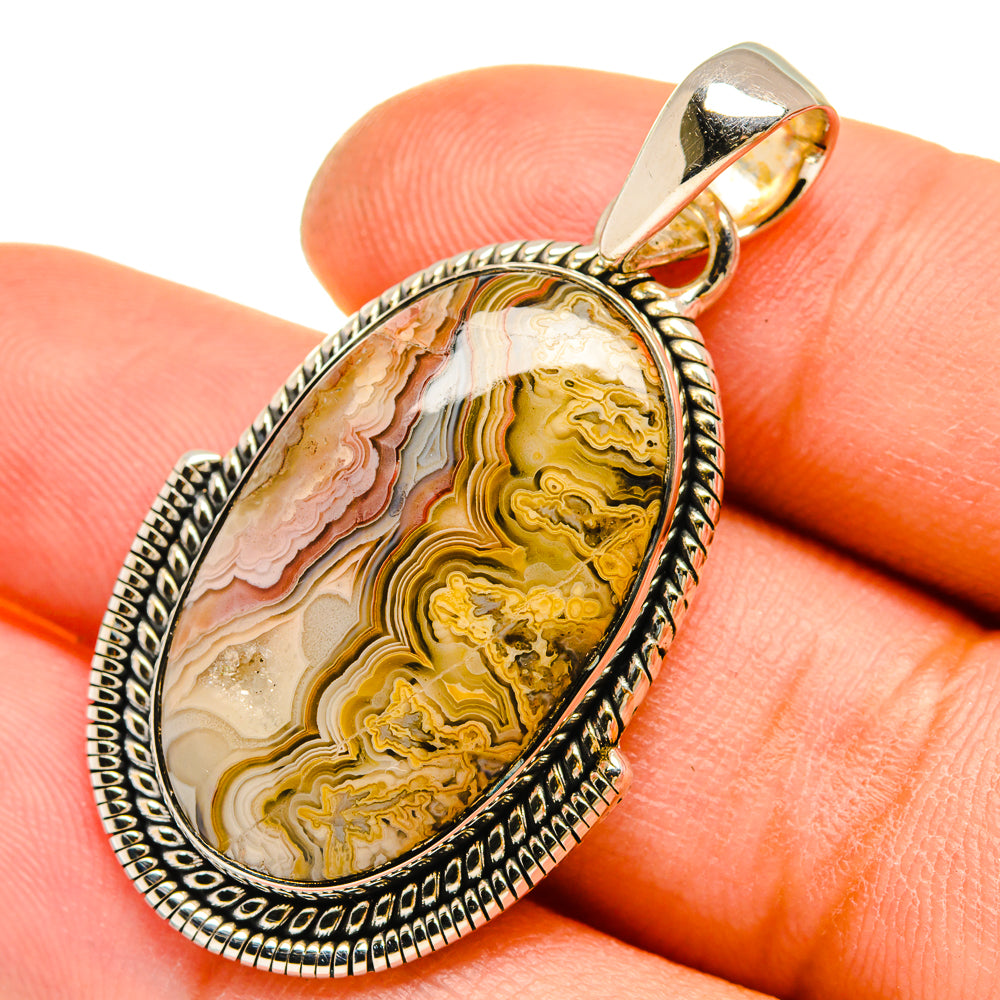 Teardrop lace agate pendant with silver bezel and bail; yellow, cream, pink, brown stone