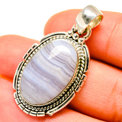 Sterling silver lace agate pendant with oval cabochon showing swirling blue-gray bands