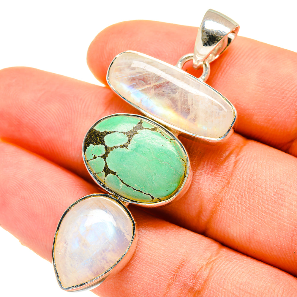 Silver-tone pendant with green turquoise oval and two white opalescent stones, bail top
