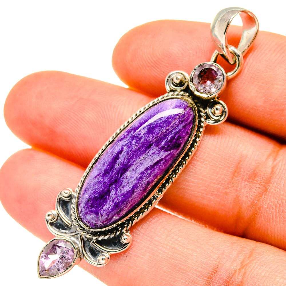 Amethyst and silver pendant with oval purple stone, round and teardrop accents
