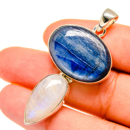 Blue oval gemstone pendant with iridescent white oval stone in silver setting