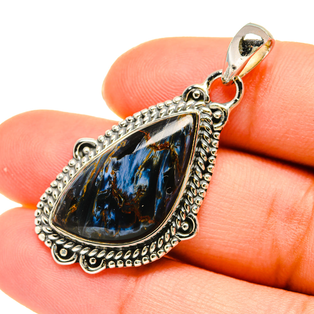 Pietersite sterling silver teardrop pendant with ornate bezel and blue black stone