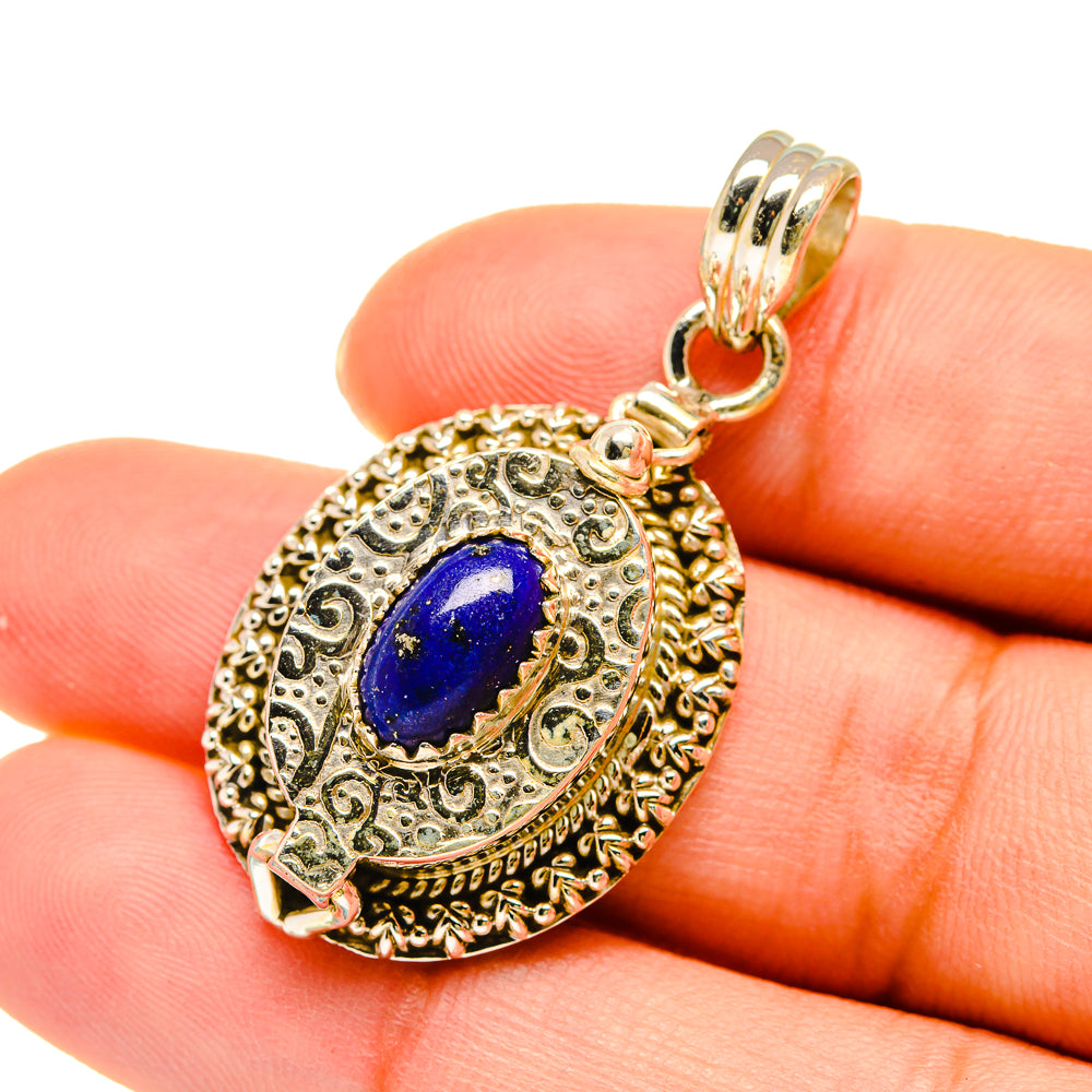 Lapis lazuli poison pendant in gold-tone filigree with blue oval stone, bail loop