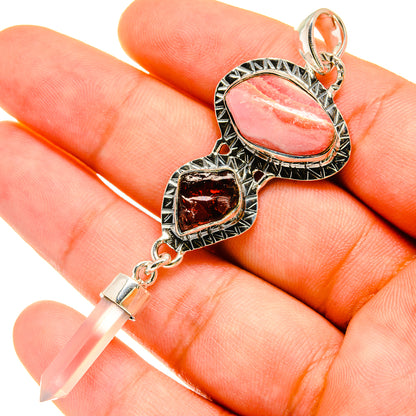 Pink oval stone and dark red heart stone pendant with ornate silver bail and chain clasp.