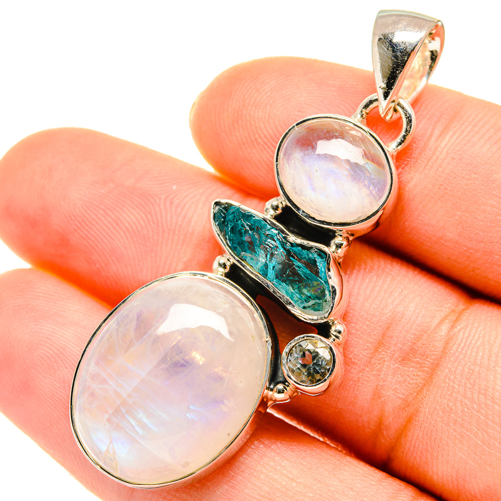 Sterling silver pendant with two oval opal-like stones, teal accent, and round blue gem