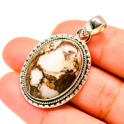 Oval red jasper pendant in sterling silver bezel with loop bail