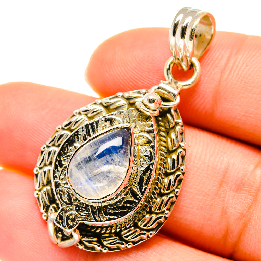 Moonstone teardrop pendant close-up with ornate frame, bail, and iridescent stone