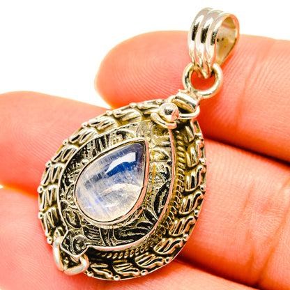 Moonstone teardrop pendant close-up with ornate frame, bail, and iridescent stone