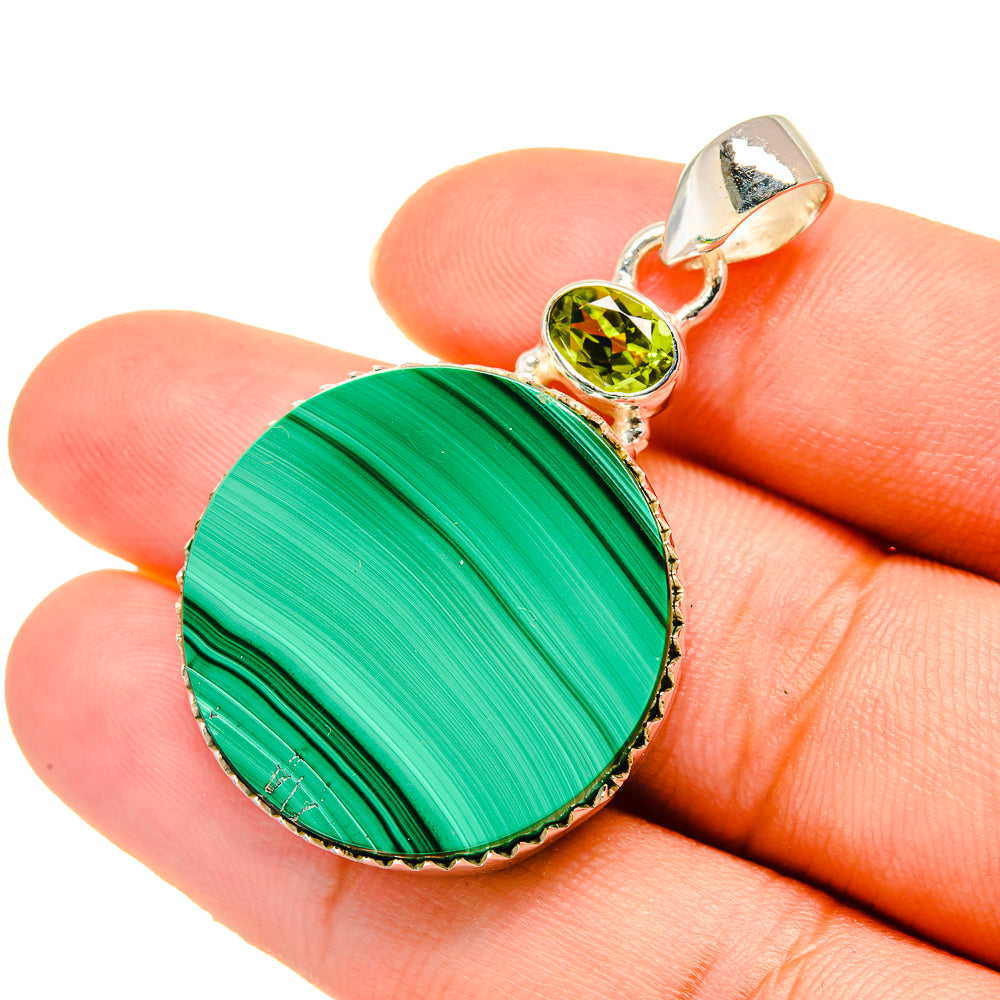 Round malachite pendant in 925 sterling silver with peridot gemstone and loop bail.