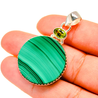Round malachite pendant in 925 sterling silver with peridot gemstone and loop bail.