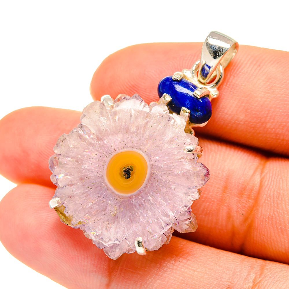 Sterling silver pendant close-up: pink amethyst geode slice with yellow center, blue bead