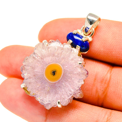 Sterling silver pendant close-up: pink amethyst geode slice with yellow center, blue bead