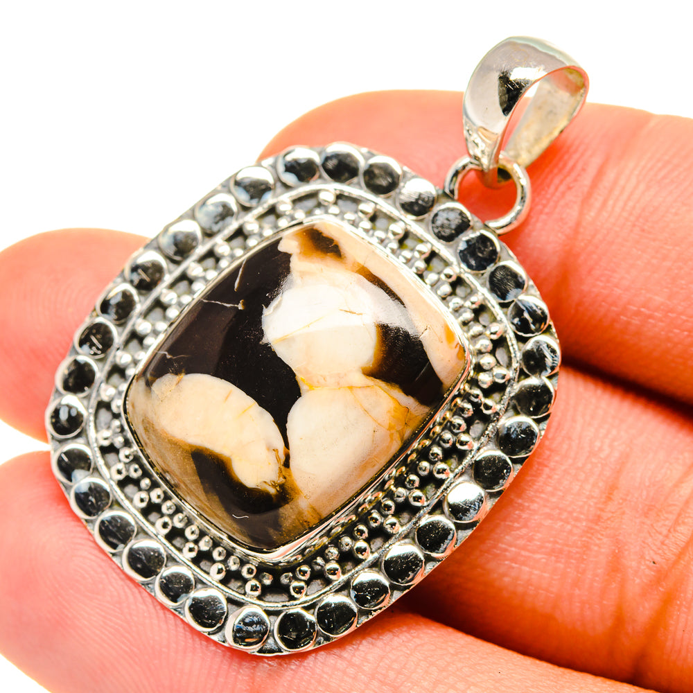 Sterling silver oval jasper pendant with black, cream, and orange stone and bail