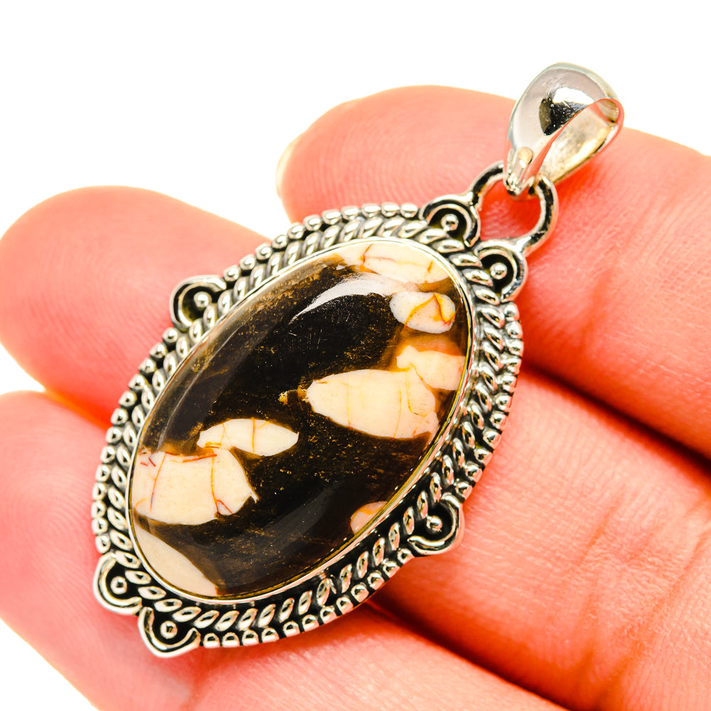 Jasper pendant in oval bezel, black and tan marbled stone with ornate silver frame