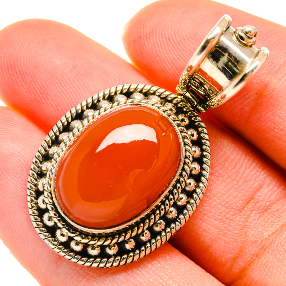Red onyx pendant in sterling silver with ornate oval bezel and bail