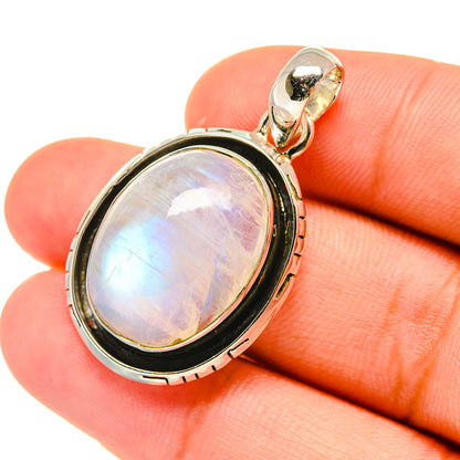 Sterling silver rainbow moonstone pendant with oval cabochon and hanging bail, bezel setting