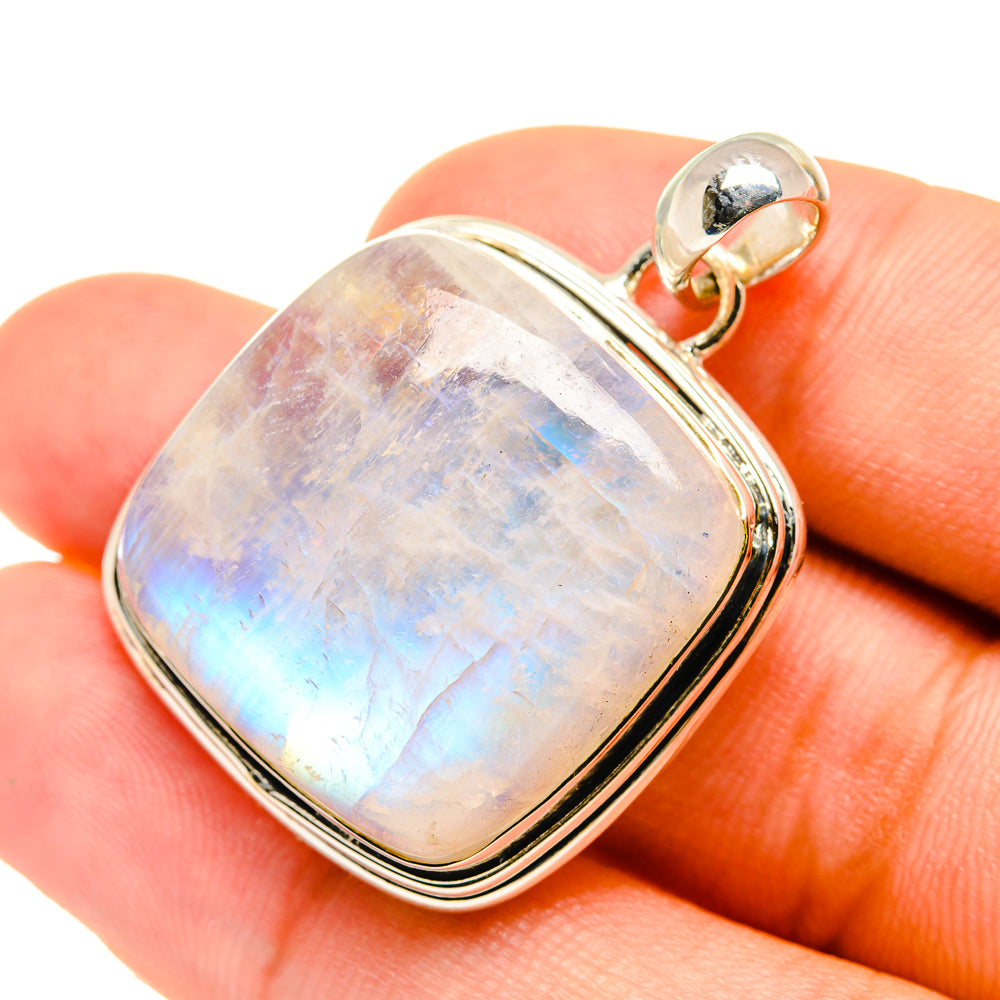 Sterling silver oval moonstone pendant with prismatic iridescence, worn on bail