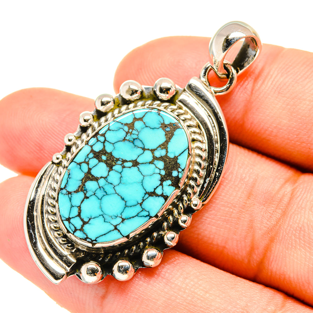 Turquoise oval pendant in sterling silver with ornate bezel and scalloped edge
