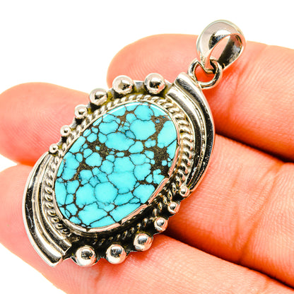 Turquoise oval pendant in sterling silver with ornate bezel and scalloped edge