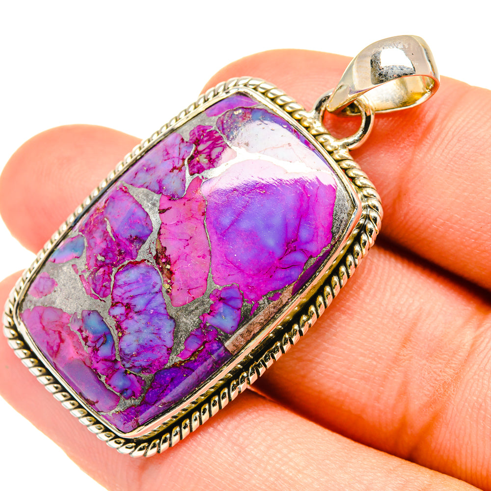 Purple composite turquoise pendant with silver bezel, bail, and rope border.