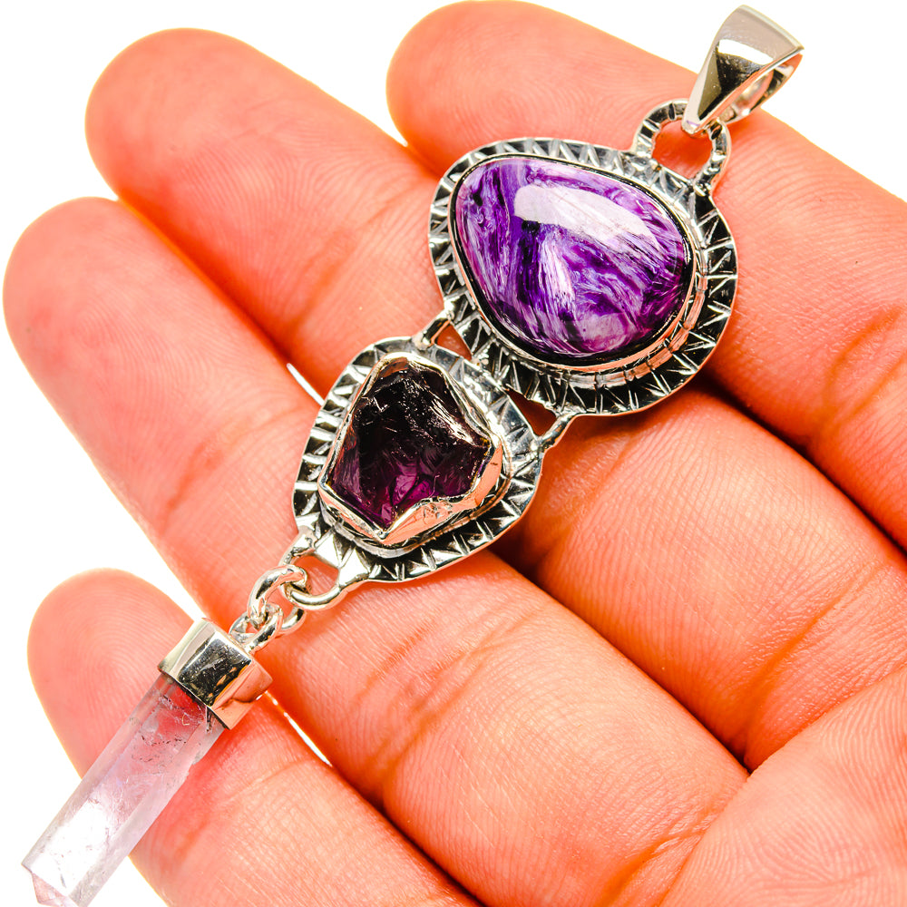 Sterling silver pendant with oval purple gemstones, decorative frame and crystal drop