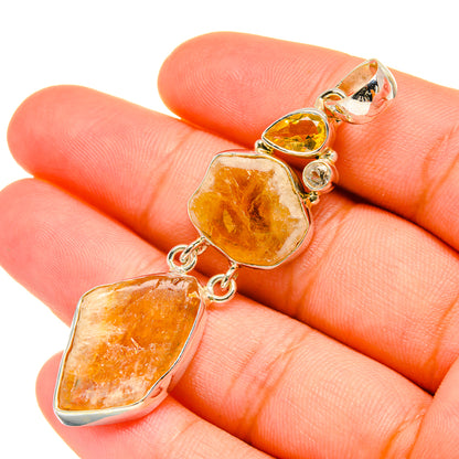 Rough citrine pendant in sterling silver with three faceted amber stones