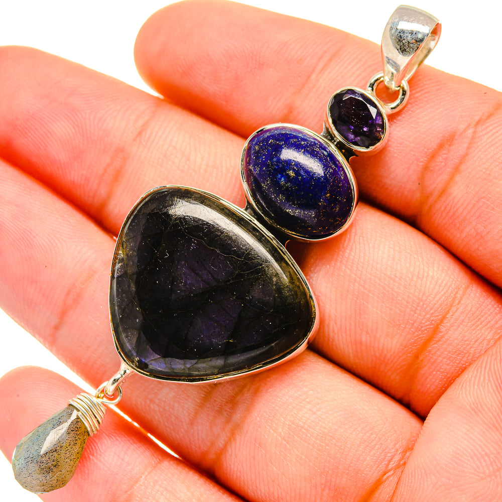 Sterling silver pendant with large black teardrop and blue round gemstone, loop bail