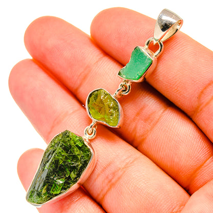 Sterling silver pendant with rough green gemstones and gold-toned accents