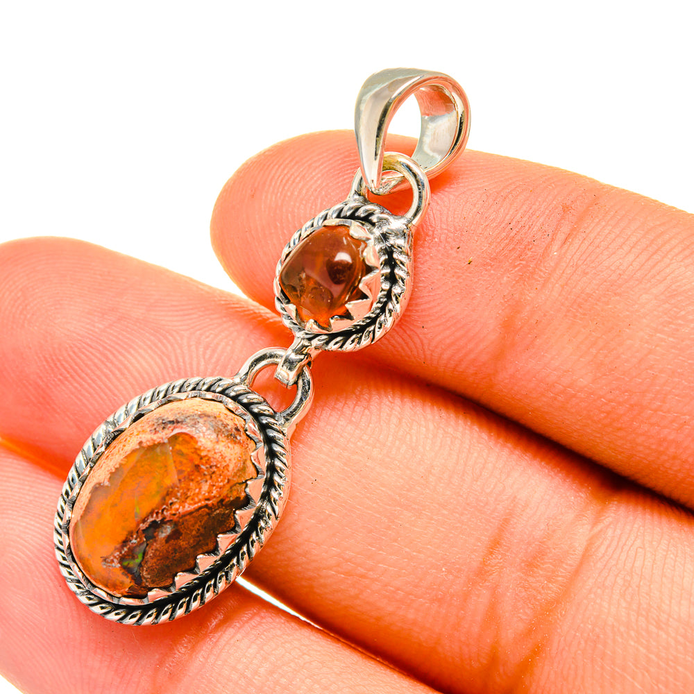 Sterling silver pendant with two orange oval gemstones in rope bezels