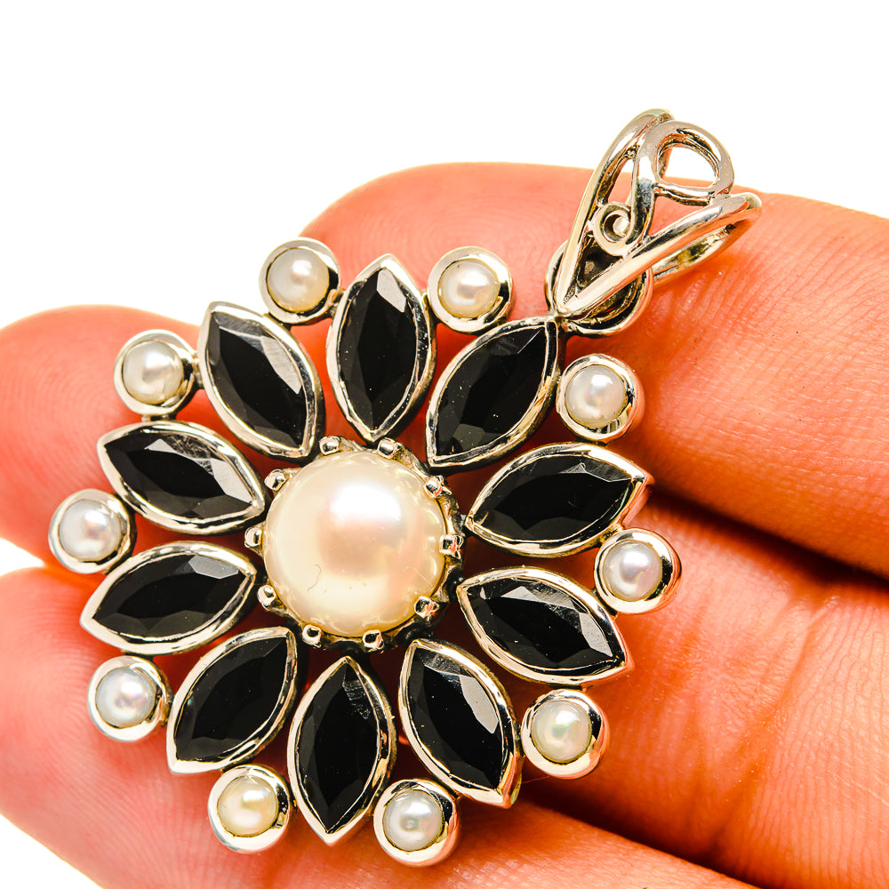 Sterling silver floral pendant with cultured pearl center and black onyx petals