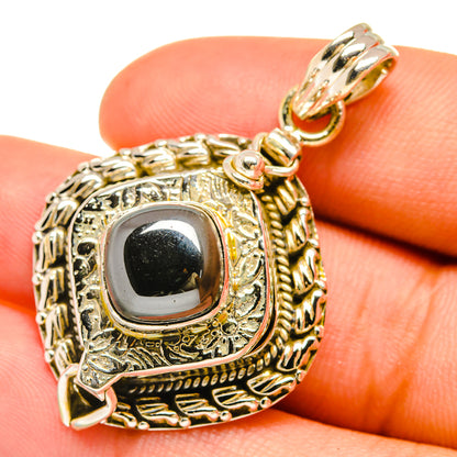 Sterling silver hematite pendant, close view of dark oval stone in decorative bezel