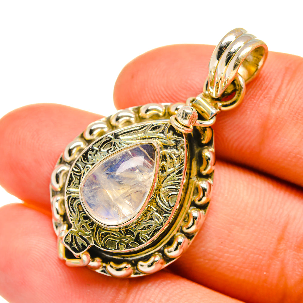 Sterling silver moonstone pendant with ornate frame and iridescent teardrop stone
