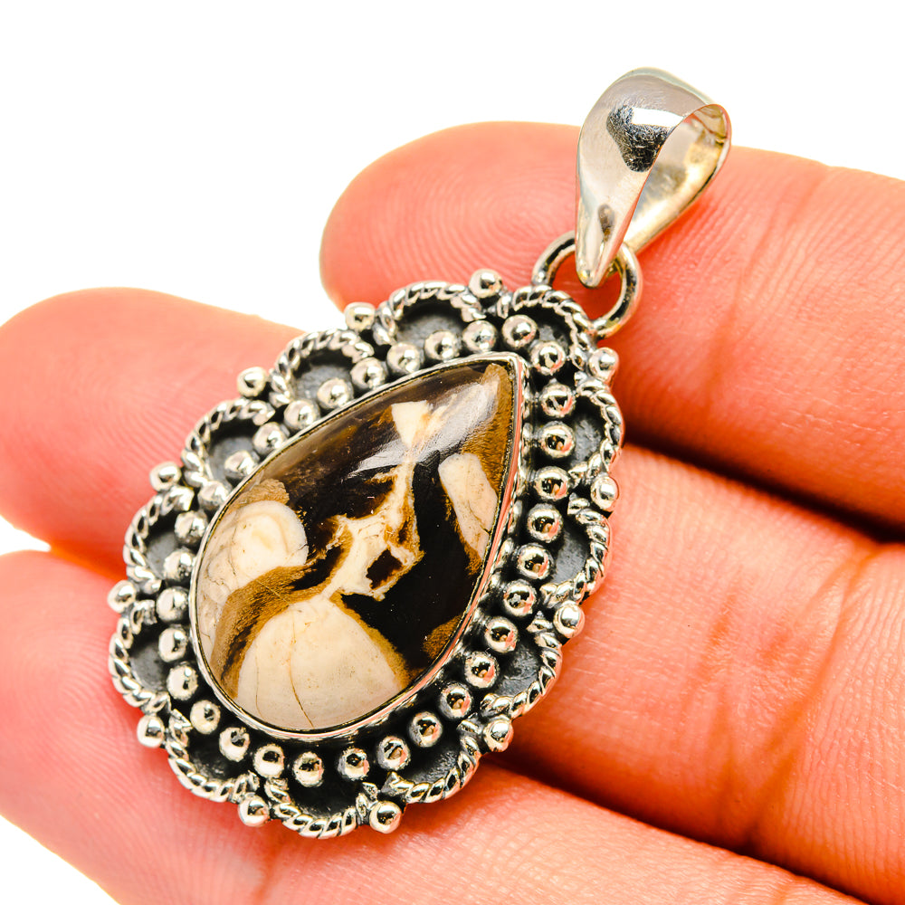 Teardrop jasper pendant with black, gold, and white pattern and beaded silver frame
