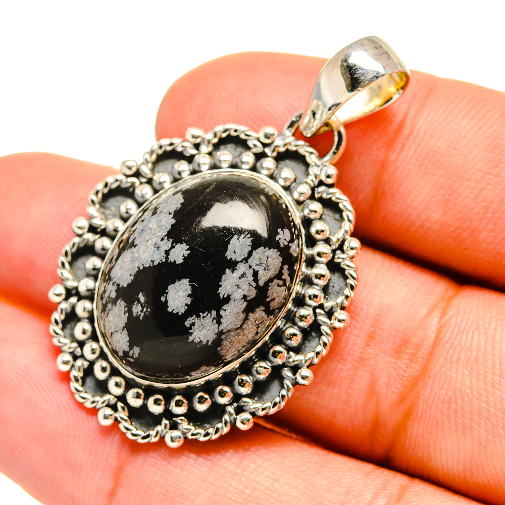 Snowflake obsidian pendant in oval setting with beaded silver border and loop bail