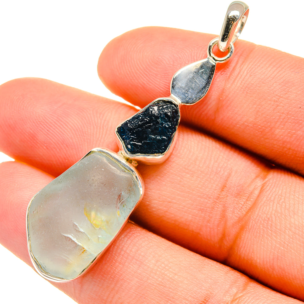 Rough blue and pale iridescent gemstone pendant, sterling silver bail in close-up