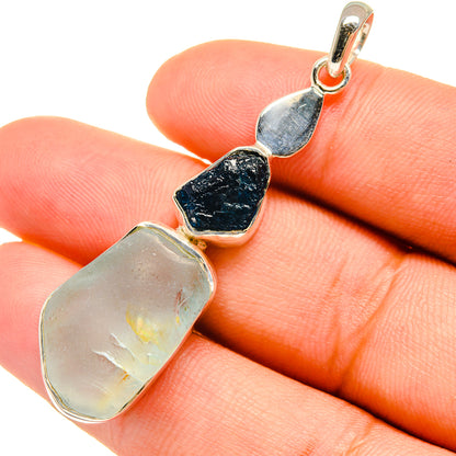 Rough blue and pale iridescent gemstone pendant, sterling silver bail in close-up