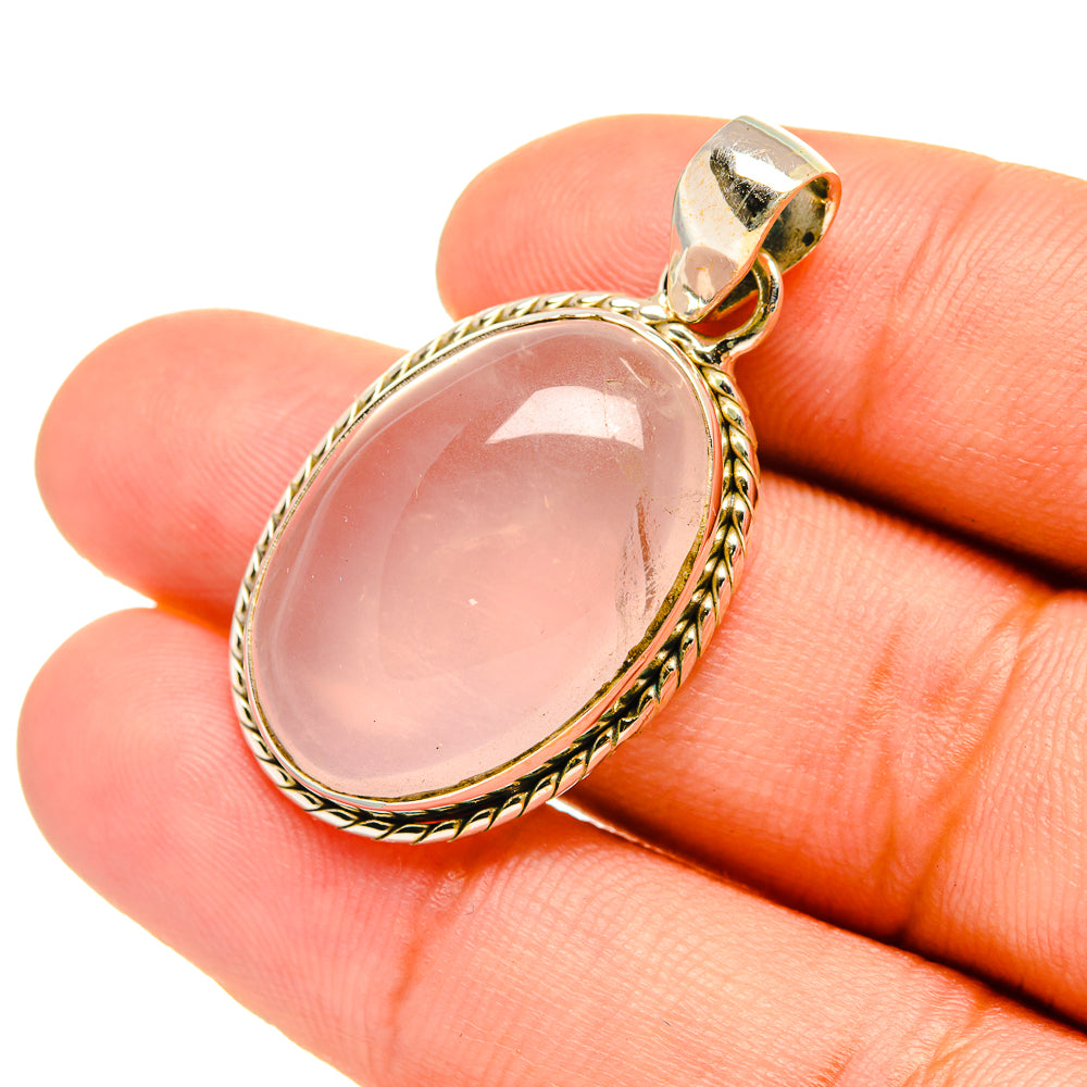 Rose quartz oval pendant with pink stone and gold-tone bail, close-up