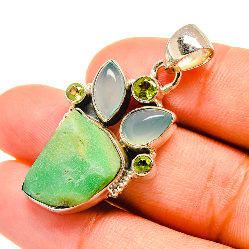 Sterling silver pendant close-up with green rough stone, aqua cabochons, and round peridot beads