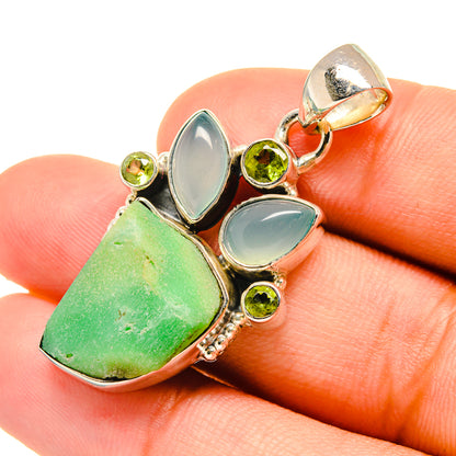Sterling silver pendant close-up with green rough stone, aqua cabochons, and round peridot beads