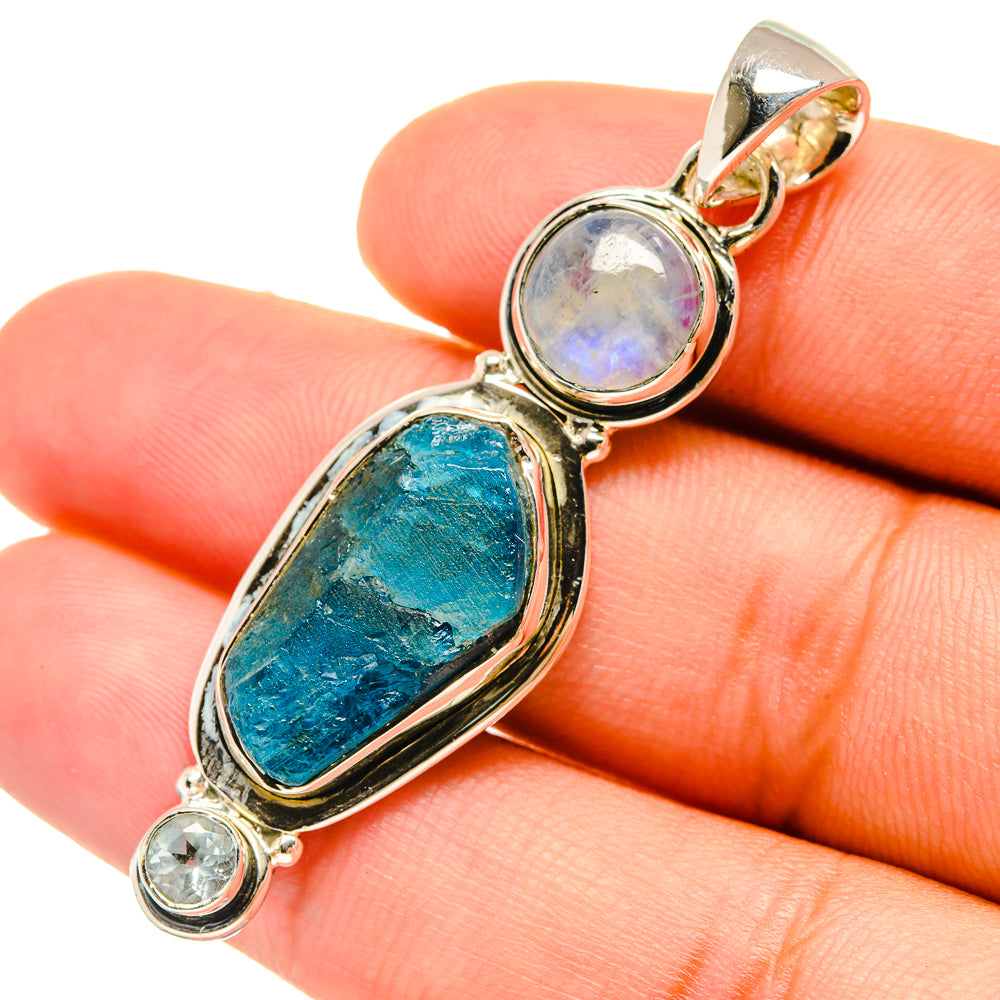 925 sterling silver pendant with oval blue gemstone, moonstone, and small clear stones